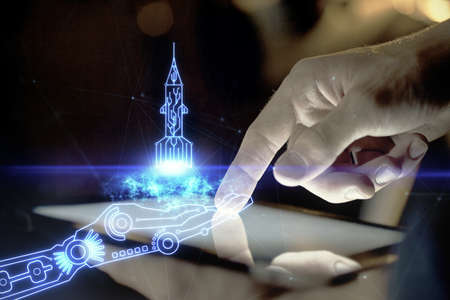 Double exposure of man's hands holding and using a mobile device and creative hologram drawing.