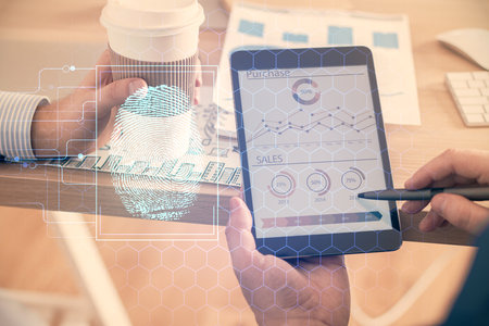 Double exposure of man's hands holding and using a digital device and fingerprint hologram drawing. Security concept.の写真素材