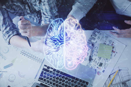 Double exposure of man and woman working together holding and using a mobile device and brain...