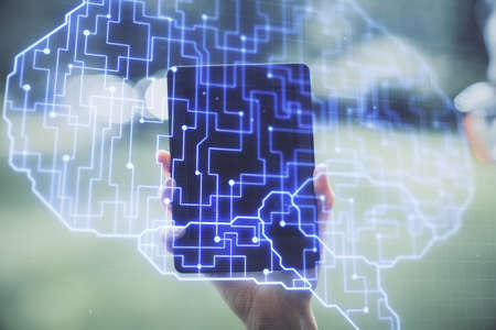 Double exposure of brain sketch hologram and woman holding and using a mobile device.
