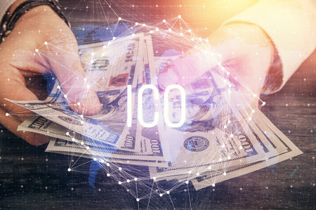 Multi exposure of blockchain theme drawing hologram and USA dollars bills and man hands. Business...