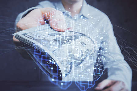 Multi exposure of brain drawing hologram and us dollars bills and man hands. Ai invest concept