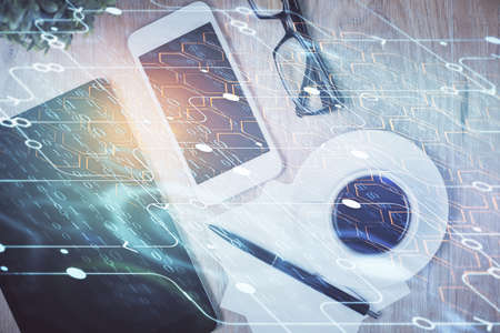 Double exposure of technology theme drawing over work table desktop. Top view. Global data analysis...