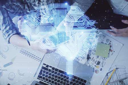Double exposure of man and woman working together holding and using a mobile device and brain...
