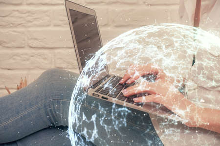 Double exposure of woman hands typing on computer and social network theme hologram drawing. People media concept.の写真素材