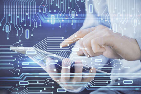 Multi exposure of man's hand holding and using a digital device and data theme drawing. Innovation...