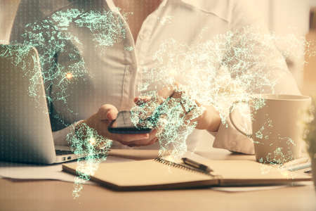 Double exposure of social network sketch hologram and woman holding and using a mobile device.