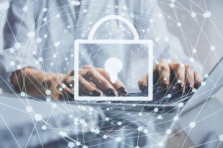 Double exposure of woman hands working on computer and lock hologram drawing. Security concept.