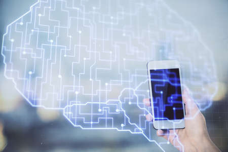 Double exposure of brain sketch hologram and woman holding and using a mobile device.