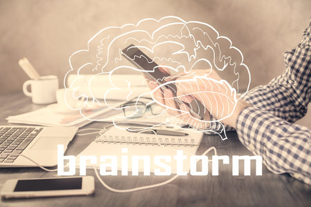 Double exposure of man's hands holding and using a mobile device and creative hologram drawing.の写真素材