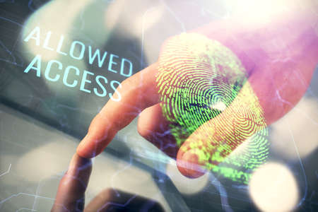 Double exposure of man's hands holding and using a digital device and fingerprint hologram drawing....