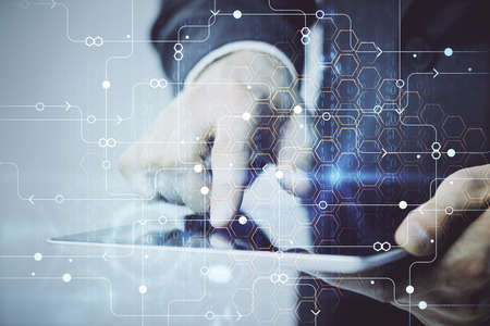 Multi exposure of man's hand holding and using a digital device and data theme drawing. Innovation...