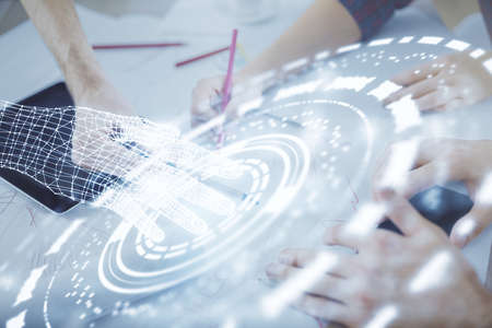 Double exposure of data theme hologram drawing and man and woman working together holding and using a mobile device.の写真素材