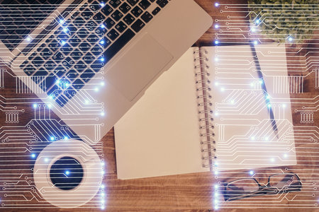 Technology hologram drawing over computer on the desktop background. Top view. Double exposure. Tech concept.の写真素材