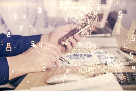 Double exposure of man's hands holding and using a digital device and tech theme hologram drawing....