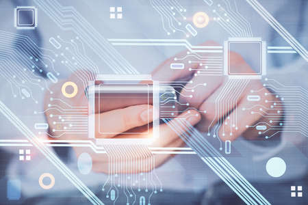 Multi exposure of man's hand holding and using a digital device and data theme drawing. Innovation...