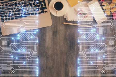 Technology hologram drawing over computer on the desktop background. Top view. Double exposure. Tech concept.の写真素材