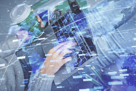 Double exposure of woman hands working on computer and data theme hologram drawing. Tech concept.