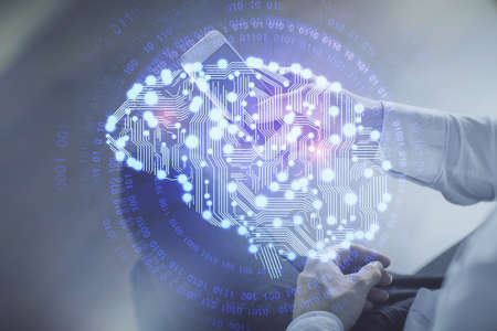 Double exposure of man's hand holding and using a digital device and brain hologram drawing. Data concept.の写真素材
