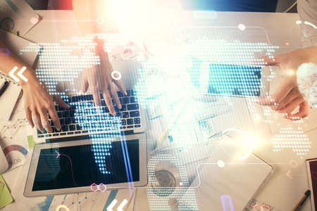Double exposure of man and woman working together and world map hologram drawing. international...