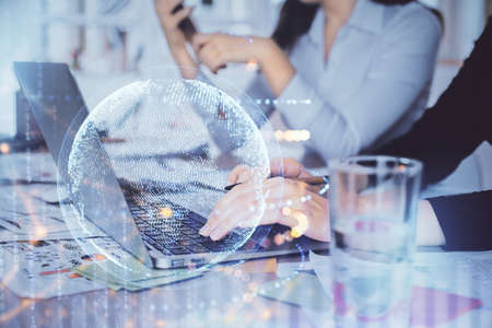 Double exposure of woman hands working on computer and world map hologram drawing. International...