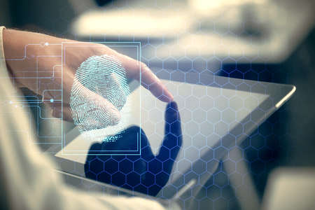 Double exposure of man's hands holding and using a digital device and fingerprint hologram drawing. Security concept.の写真素材