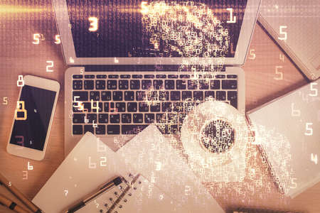 Technology hologram drawing over computer on the desktop background. Top view. Double exposure. Tech concept.の写真素材