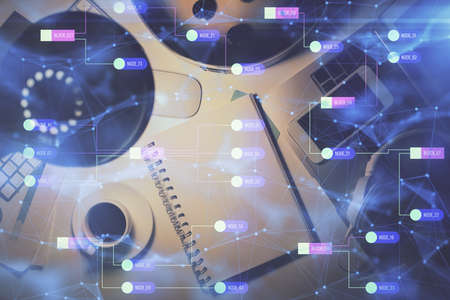 Double exposure of technology theme drawing over work table desktop. Top view. Global data analysis...