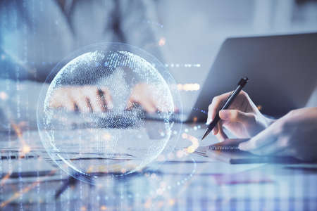 Double exposure of woman hands working on computer and world map hologram drawing. International...