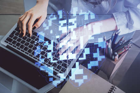 Double exposure of woman hands working on computer and data theme hologram drawing. Tech concept.の写真素材