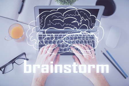 Double exposure of man's hands typing over computer keyboard and conceptual start up theme drawing....