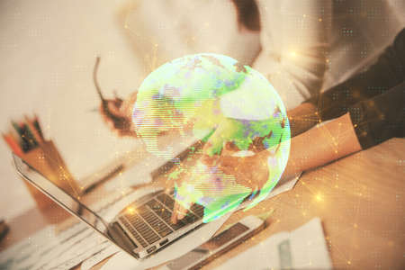 Double exposure of woman hands typing on computer and social network theme hologram drawing. People media concept.の写真素材