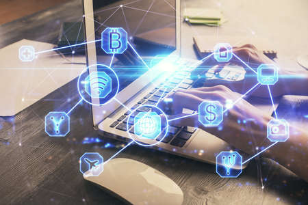 Double exposure of woman hands typing on computer and social network theme hologram drawing. People...