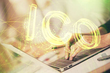 Double exposure of woman hands typing on computer and crypto market theme hologram drawing....