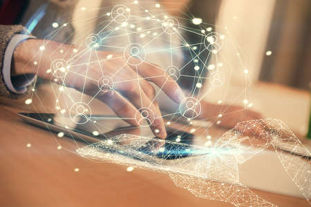 Double exposure of social network theme drawing and man and woman working together holding and using...