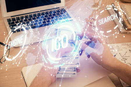Multi exposure of blockchain theme drawing hologram and USA dollars bills and man hands. Business...