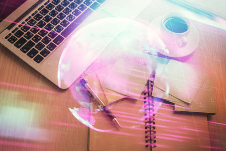 Technology hologram drawing over computer on the desktop background. Top view. Double exposure. Tech concept.の写真素材