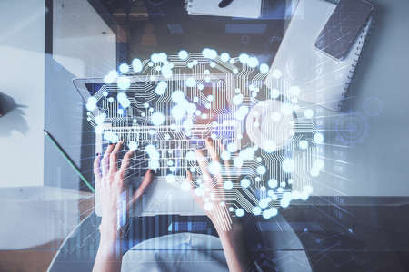 Double exposure of woman working on computer andhuman brain hologram drawing. Top View. Ai concept.