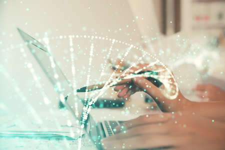 Double exposure of woman hands typing on computer and DNA hologram drawing. Medical education...