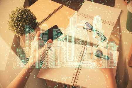 Multi exposure of woman on-line shopping holding a credit card and construction drawing. e-commerce concept.の写真素材