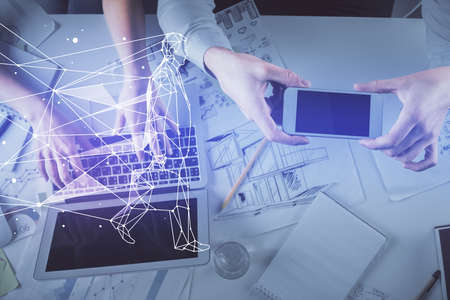 Double exposure of man and woman working together and creative hologram drawing. Computer...
