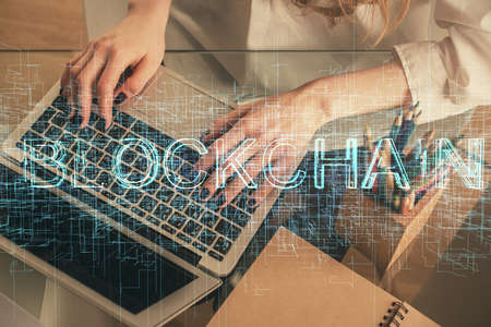 Double exposure of woman hands typing on computer and crypto market theme hologram drawing....
