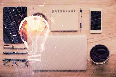 Double exposure of bulb drawing over table with phone. Top view. Concept of idea.