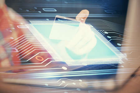Double exposure of man hands holding a credit card and data theme drawing. E-commerce and technology...