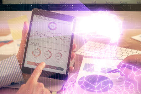 Double exposure of man's hands holding and using a digital device and AR glasses drawing. Virtual...
