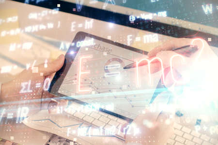Double exposure of man's hands holding and using a phone and formulas drawing. Education concept.