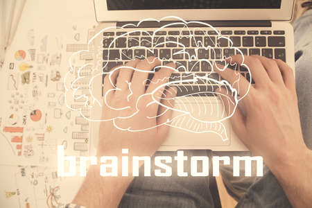 Double exposure of man's hands typing over computer keyboard and conceptual start up theme drawing. Top view.の写真素材