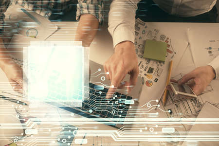 Double exposure of man and woman working together and data theme hologram drawing. Computer...