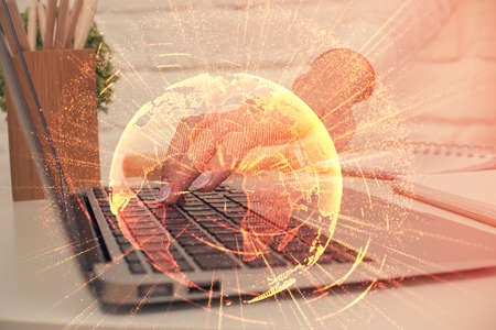 Double exposure of woman hands typing on computer and social network theme hologram drawing. People...