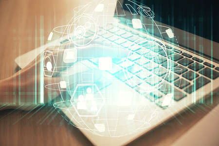 Double exposure of woman hands typing on computer and social network theme hologram drawing. People...